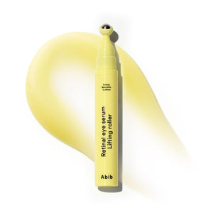 Abib Retinal Eye Serum Lifting Roller applicator being used to massage and firm the under-eye area for wrinkle reduction.